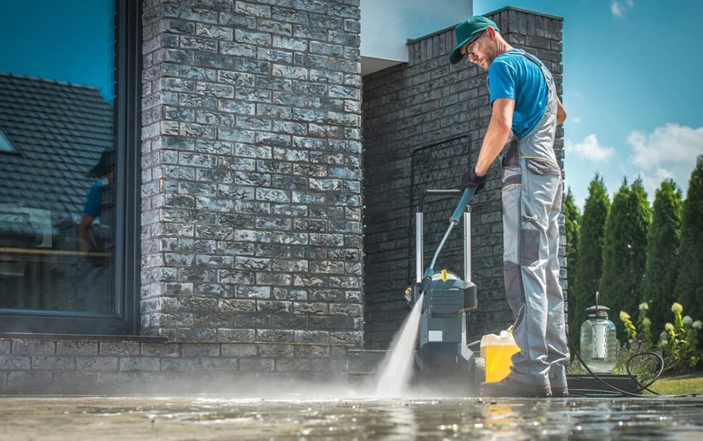 Skilled professional power washing a brick surface, ensuring deep cleaning and restoration by Gotta Guy PA, LLC in Lake Ariel, PA.