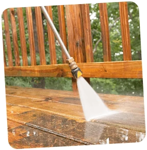 Close-up of Gotta Guy PA, LLC's power washing service cleaning a wooden fence, maintaining the aesthetics of outdoor spaces in Lake Ariel, PA.